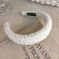 Close-up of beige tweed headband with Hand Made label on a vintage book - Thick Tweed Style (19539A)