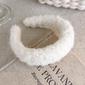 Close-up of cream fuzzy headband on a book showing thick faux shearling texture - Teddy Fleece Padded Style (26359A)
