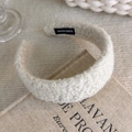 Close-up of a white plush headband with handmade woven label on soft textured fabric - Artificial Lamb Plush Style (27649A)