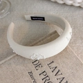 Detail of beige sponge headband with handmade pearl flower accents on a vintage book - Artificial Pearl Embellished Style (26457C)