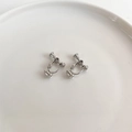 Adjustable silver spiral ear clip converters for non-pierced earrings on a white tray - Platinum Spiral Bullet Clip