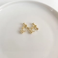 Adjustable golden screw-back earring converters for non-pierced ears on ceramic tray - Gold Spiral Bullet Clip