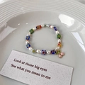 Detail of beaded bracelet with freshwater pearls, glass flowers, and a pink cherry charm - Style B Cherry