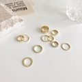 Minimalist 10-piece gold plated ring set with various smooth and textured band designs - Gold