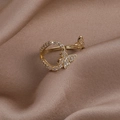 Close-up of golden butterfly ring with white cubic zirconia on brown silk background - Style A Two Butterflies
