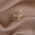 Detailed view of adjustable gold butterfly ring with cubic zirconia on champagne silk - Style C Four Butterflies
