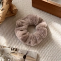 Close-up of a light brown plush scrunchie with soft faux fur texture for winter hair styling - Brown