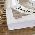 Close-up of rose gold bean-shaped earrings with micro-pave cubic zirconia on a gift box - A Rose Gold