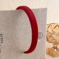 Detailed texture of burgundy velvet padded headband against a linen and glass background - Dark Red Flocked Padded Style (9# 21838C)