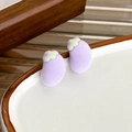 Detailed macro view of flocking fruit stud earrings with soft purple matte finish - Eggplant