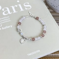 Detail of beaded moon bracelet with silver key charm and strawberry quartz beads - Orange