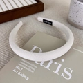 Detailed texture of beige pinstripe headband featuring a hand-made label on inner side - White
