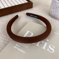 Close-up of brown pinstripe padded headband with a handmade label on a book - Dark Coffee
