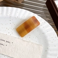 Detail of a rectangular tortoiseshell acetate hair clip with France Handmade gold lettering - Orange Spring Clip