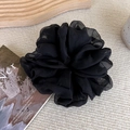 Close-up of large black organza scrunchie with soft ruffles on a wooden tray - Black