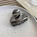 Metallic gunmetal pearl wave claw clip with a glossy mirror finish in a decorative tray - Irregular Style Gun Black (22603C)