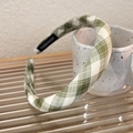 Detailed view of green and white checkered headband featuring a handmade fabric tag - Medium Green White Plaid
