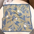 Detailed view of 100% mulberry silk scarf with blue floral print and smooth texture - 53x53 / Green Orchid Branch