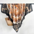 Luxurious orange and beige scarf with carriage patterns and tassel edges hanging vertically - Black