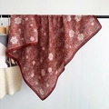Detail of dark red camellia print scarf with fine grid texture hanging on a black rack - Red / 90x90cm