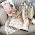Detail view of premium floral satin square scarf with elegant orange and blue flower patterns - Beige / 65x65cm