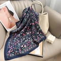 Detail of floral silk scarf draped on white leather bag in a cozy home setting - Navy Blue / 65x65cm