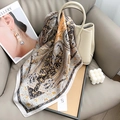 Primer plano de un pañuelo de seda con estampado paisley sobre un bolso de cuero - 70cm*70cm / Blanco