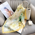 Elegant yellow floral silk scarf for women displayed on a leather sofa with luxury props - Yellow