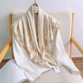 Floral imitation silk scarf in beige and brown styled over a white blouse on a chair - Light Coffee