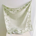 Detailed view of floral pattern and lightweight texture on green silk-like square scarf - Light Green
