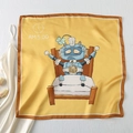Close-up of square satin scarf featuring yellow base and blue robot illustration - I, Robot