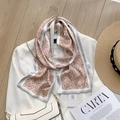Dettaglio di un foulard in raso con stampa a catena morsetto su un blazer bianco - Maglia di Catena Rosa