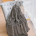 Classic black and white houndstooth cotton linen shawl draped over an armchair - Black