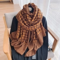 Classic tan houndstooth scarf draped on a chair with black sweater and stylish accessories - Brown