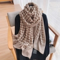 Brown houndstooth cotton linen scarf draped on black sweater in bright indoor setting - Brown