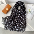 Detail of a lightweight black and white polka dot beach shawl on white marble background - Black Polka Dot Style (YRS109-1)