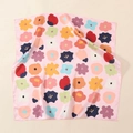 Detailed view of pink satin square scarf featuring vibrant colorful floral prints and silk texture - Pink