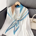 Geometric striped silk scarf in blue and brown styled on a white shirt collar - Blue