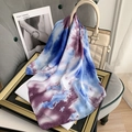 Artistic blue and purple tie-dye silk scarf draped on a bag in a stylish setting - Light Blue