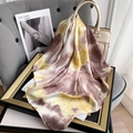 Detail of vintage tie-dye silk scarf draped over a beige handbag and elegant frame - Light Yellow