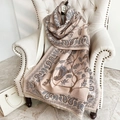 Détail du motif paisley et oiseaux sur une écharpe rose aspect cachemire sur chaise - Rose Riz