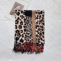 Detail of leopard print scarf with red contrast lining and fringed edges on white cloth - Light Brown (P11)
