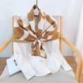 Detail of silk satin scarf with caramel and cream geometric pattern on wood chair - Brown / 90*90cm