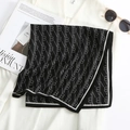 Detail of soft wool-feel scarf featuring black and white monogram pattern and brand tag - Black / 68*68cm