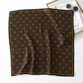 Close-up of retro black and gold silk square scarf with vintage heraldic patterns - Black & Gold