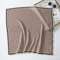 Close-up of a pink silk scarf featuring a geometric ring pattern and black border accents - Bandana / Light Khaki