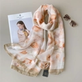 Detail of soft off-white chiffon scarf with orange floral prints and metal tag accessory - Light Brown Print
