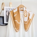 Elegant floral silk-feel square scarf in yellow and white draped over a white shirt - 68x68cm / Yellow