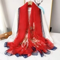 Detailed view of large red floral scarf with blue borders and elegant white flower patterns - Red Floral Cluster Style