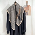 Detail showing high-quality black and white striped scarf paired with a black dress - Khaki Edge